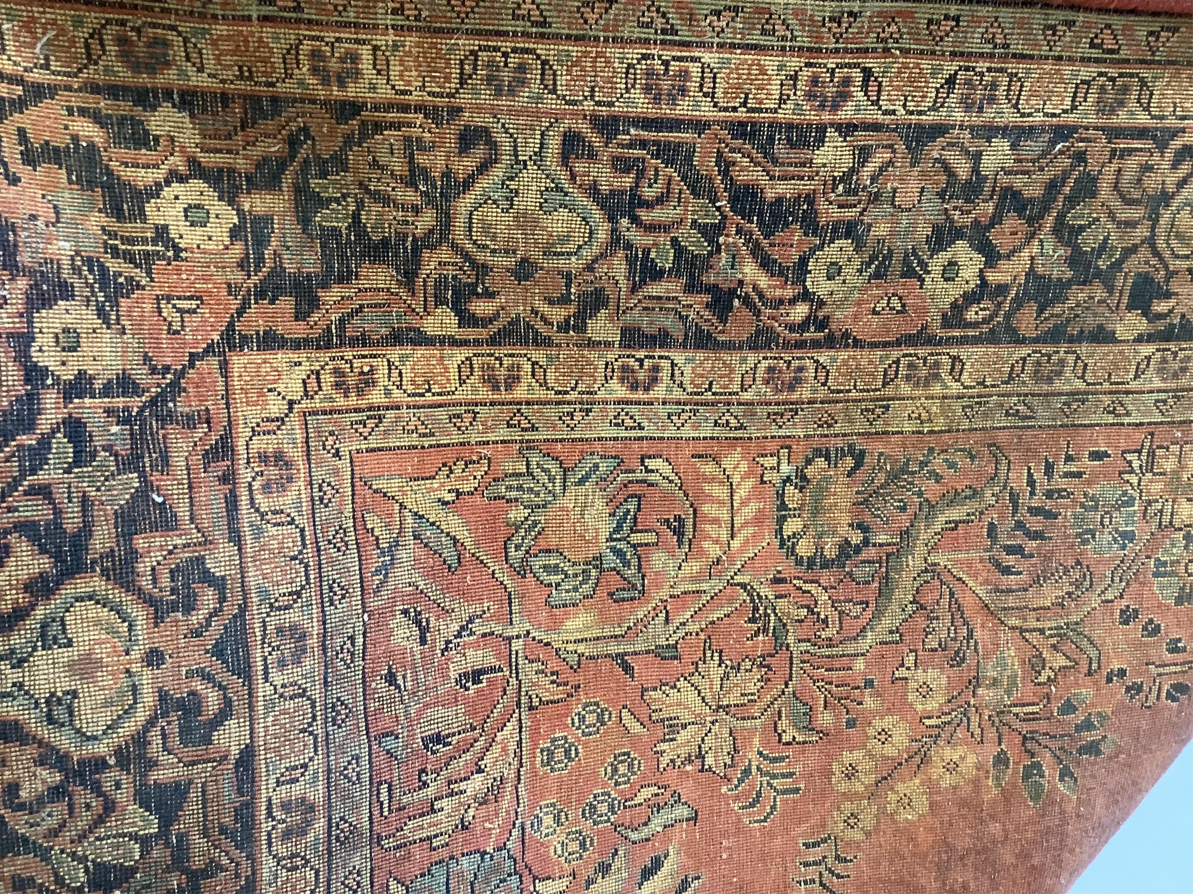 A Sarouk red ground rug, 251 x 154cm
